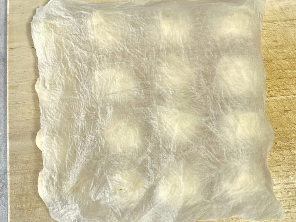 まな板の上にのせた「ちぎりパン」の生地に濡らしたキッチンペーパーを被せ、一次発酵させている様子